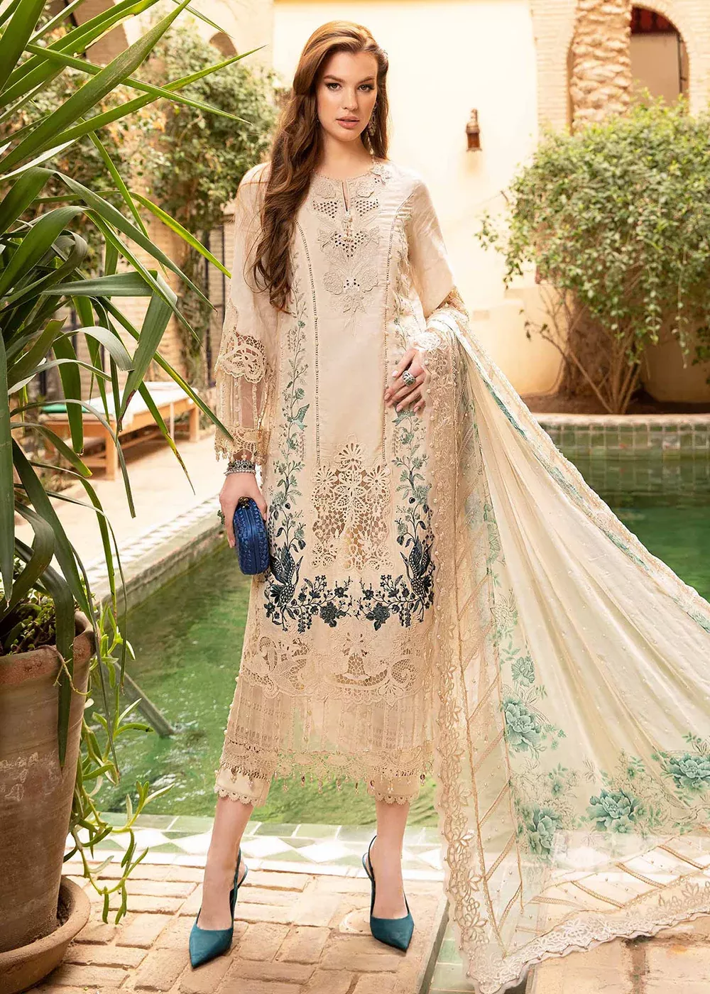 Elegant lawn suit with minimal embroidery and clean cuts, styled as professional office wear for women