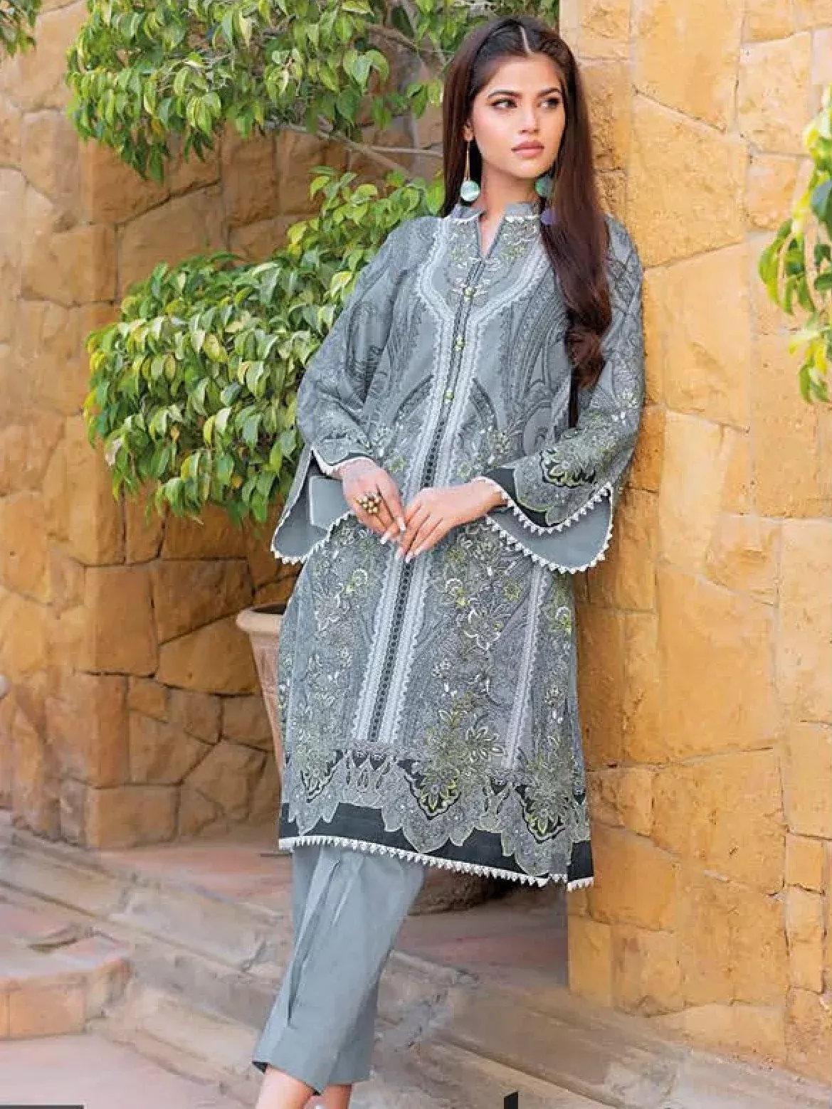 Pakistani lawn suit with professional hem details and accessories on a neutral background.